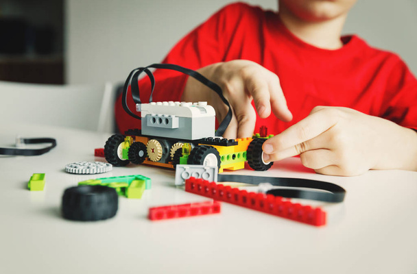 boy building robot at robotic technology school lesson - Фото, зображення