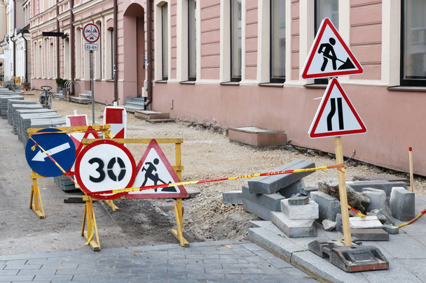 Señales de tráfico limitan la zona de reparación y renovación de una calle peatonal en la antigua zona histórica de la capital del Báltico
 - Foto, Imagen