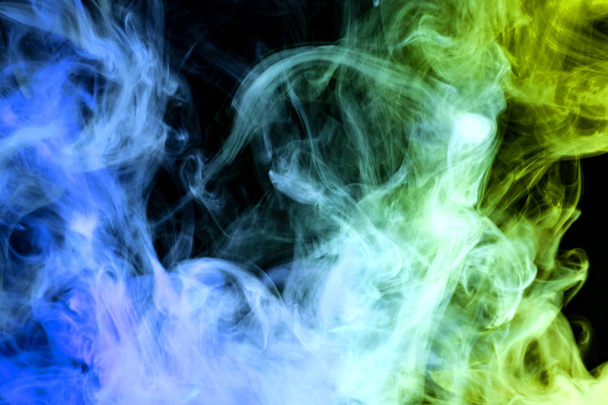 Green, yellow and blue  cloud smoke on black  isolated backgroun - Photo, Image
