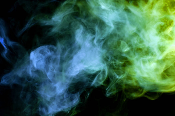 Green and blue cloud of smoke of  black isolated background. Background from the smoke of vap - Photo, Image