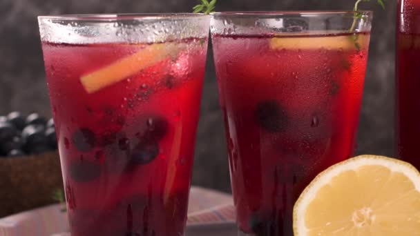 Fresh blueberry summer mojito cocktail. Blueberry lemonade or sangria on kitchen countertop. - Felvétel, videó