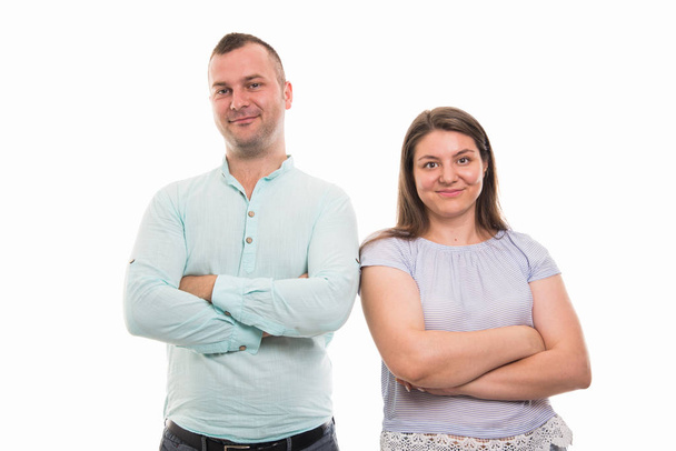 Portrait of young happy couple standing with arms crossed gesture isolated on white background with copyspace advertising area - Zdjęcie, obraz