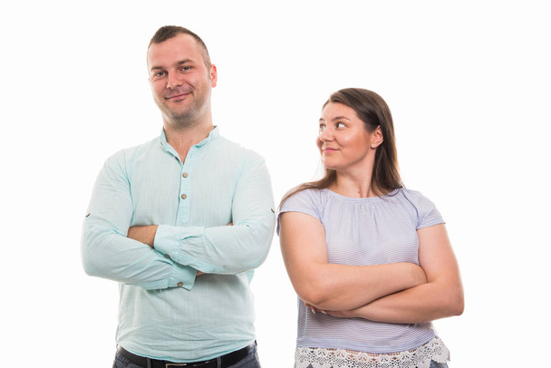 Portrait of young happy couple standing with arms crossed gesture isolated on white background with copyspace advertising area - Φωτογραφία, εικόνα
