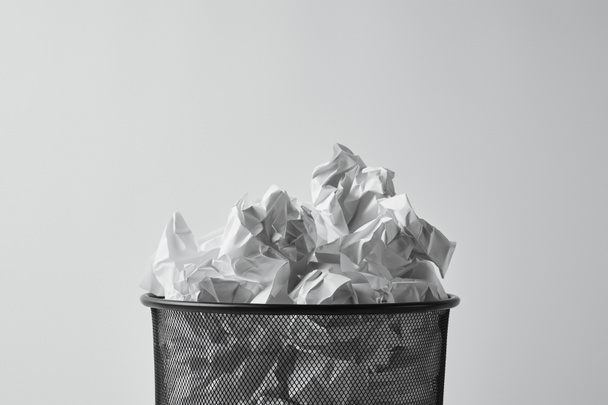 close-up shot of office trash bin with crumpled papers isolated on white - Fotografie, Obrázek