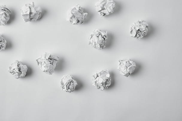top view of spilled crumpled papers on white surface - Zdjęcie, obraz