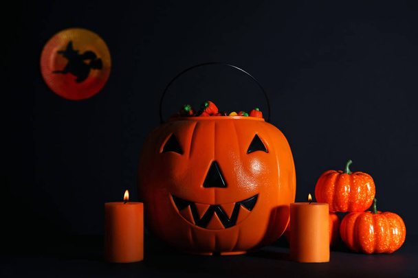 Halloween pumpkins with candy corns on black background - Foto, Bild