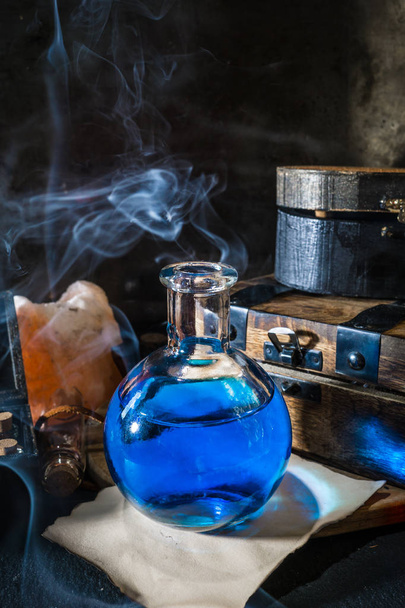 Magic concept. Blue potion in glass bottle - Photo, Image