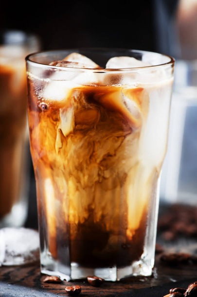 Summer cold coffee with ice and milk, brown background - Fotografie, Obrázek