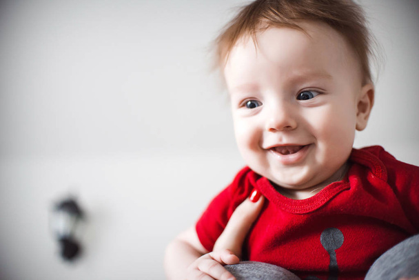 Young smiling infant boy in female hands - Фото, зображення