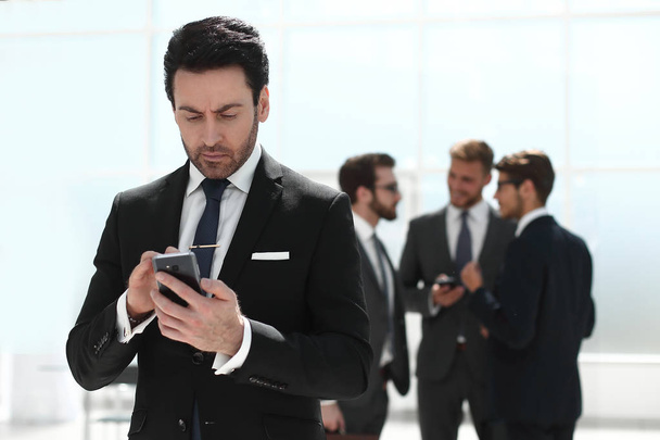 businessman typing SMS on smartphone - Fotó, kép