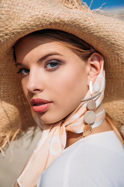 beautiful elegant lady posing in silk scarf and straw hat for fashion shoot - Fotó, kép