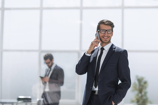 confident businessman talking on a mobile phone. - Фото, изображение
