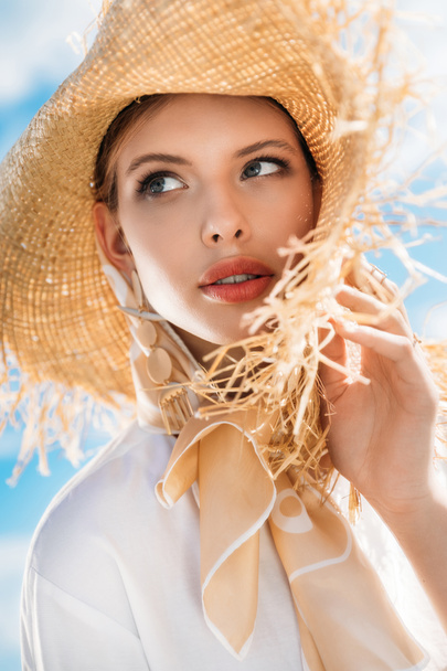 charming young woman posing in silk scarf and straw hat - Fotó, kép