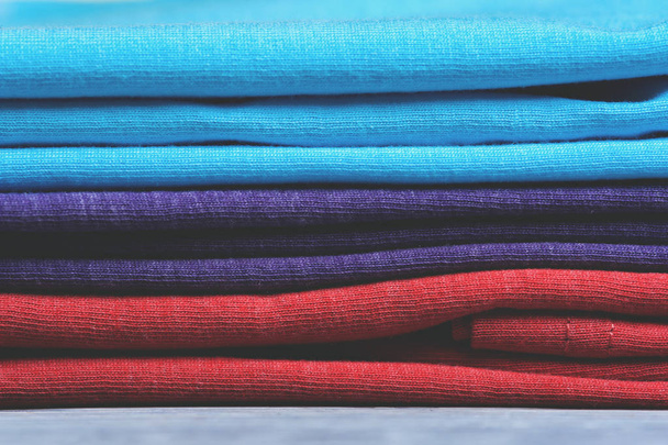 Stack of colorful t-shirts, close up - Foto, imagen