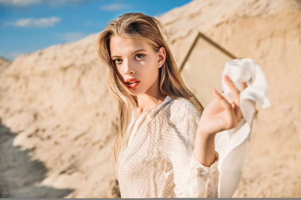 attractive blonde girl with white silk scarf walking on sand dune - Φωτογραφία, εικόνα