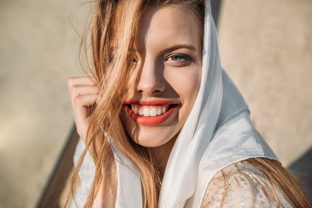 beautiful smiling girl in white silk scarf looking at camera - Fotoğraf, Görsel