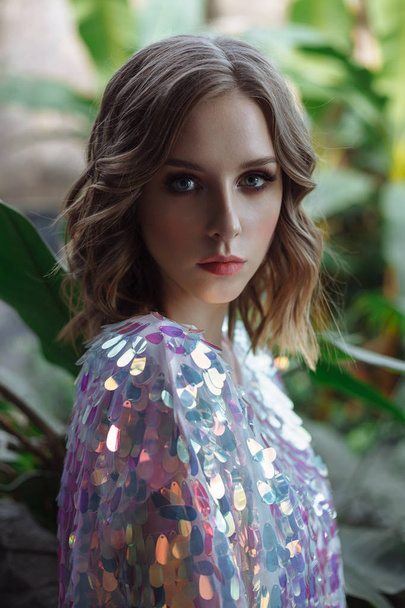 young beautiful fashion model. woman in sequin dress. girl in holographic t-shirt. tropical glamour portrait - Fotó, kép