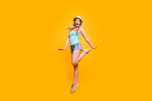 Full-size portrait of lovely girl in headwear jump and fun isolated on shine yellow background with space for text - Valokuva, kuva