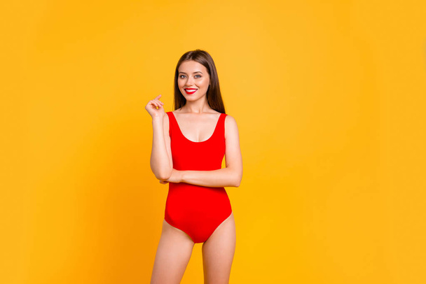 Happy and cute brunett girl with big smile looking at camera and stand isolated on vivid yellow background with copy space - Фото, изображение