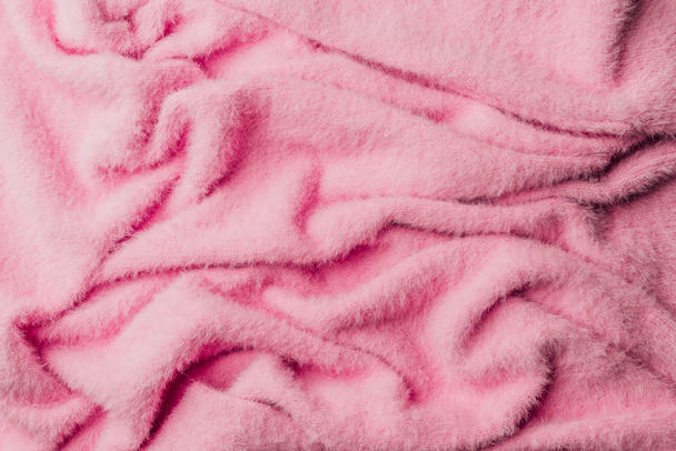 Draufsicht auf rosa Frottee weiches Textil als Hintergrund  - Foto, Bild