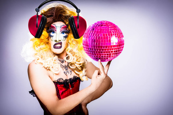 cool drag queen with spectacular makeup, glamorous stylish look, posing with   proud and  style for lgtb equality gay rights with disco ball - Фото, зображення