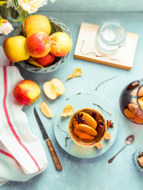Apple cider drink, hot cocktail with cinnamon sticks and apple slices. Tea with spices. Autumn sunny cozy morning mood. Romantic atmosphere. Top view, flatlay - Photo, image