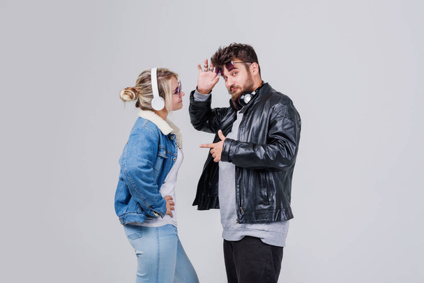Portrait of a young couple enjoying music over white background - Photo, Image