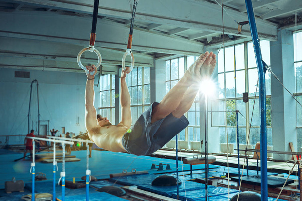 The sportsman during difficult exercise, sports gymnastics - Photo, image