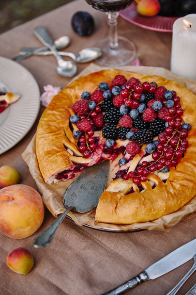 delicious berries pie on table in garden - Photo, Image