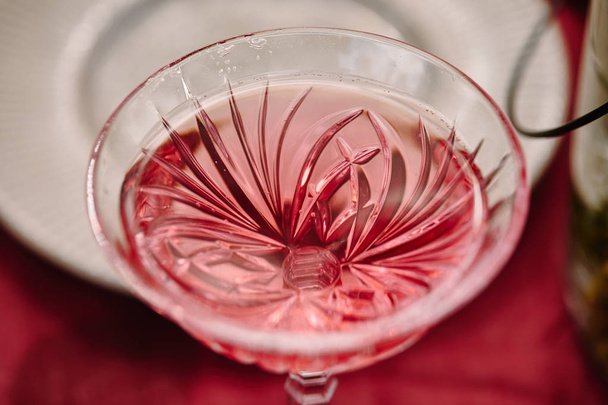 wineglass with pink wine on table in garden - Fotografie, Obrázek
