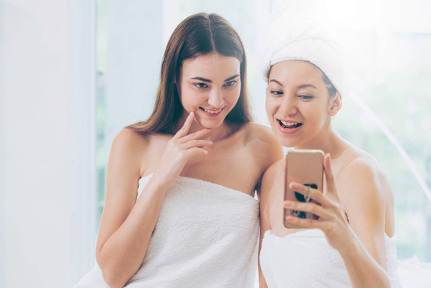 Happy women takes selfie photo with mobile phone in luxury spa after aromatherapy massage. Luxury wellness lifestyle and social media information sharing concept. - Fotó, kép