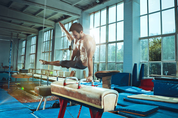 The sportsman during difficult exercise, sports gymnastics - Photo, image