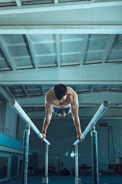 The sportsman during difficult exercise, sports gymnastics - 写真・画像