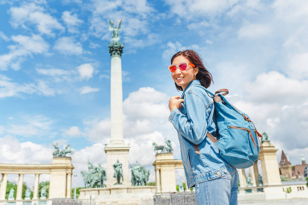An Asian woman tourist on one of the main attractions of Budapest - Heroes Square. Concept travel throughout Europe and Hungary - Photo, Image