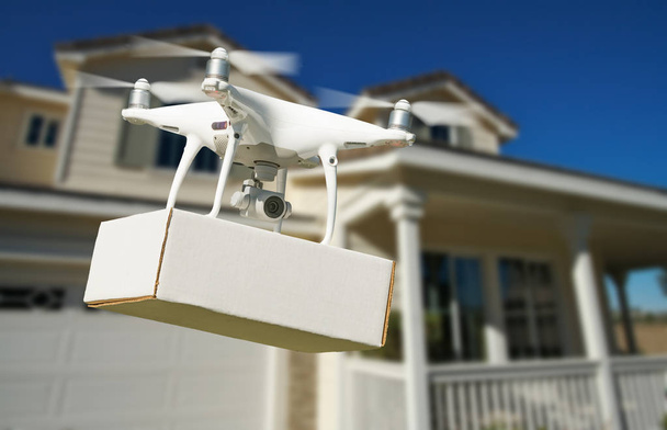 Unmanned Aircraft System (UAV) Quadcopter Drone Delivering Package At House. - Photo, Image