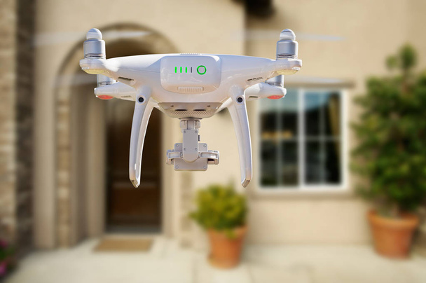 À l'arrière du quadcoptère du système d'aéronef sans pilote (UAV) Drone volant devant la maison
. - Photo, image