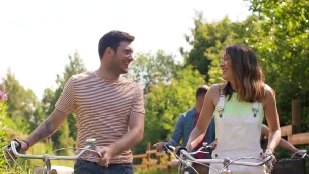 friends with fixed gear bicycles walking in park - Video