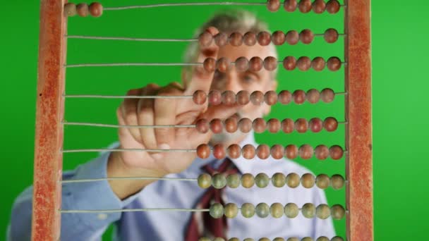 out of focus man behind old abacus, mathematical concept - Footage, Video