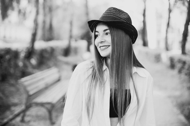 fekete-fehér fotó, lány, aki sétál a parkban található egy elegáns ruhákat - Fotó, kép