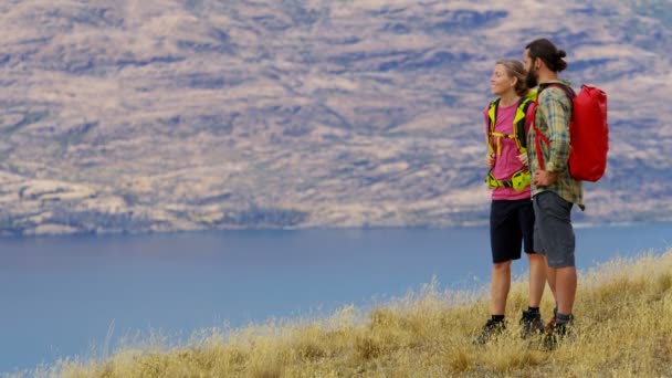 Young Caucasian adventure couple on their vacation trekking of The Remarkables Lake Wakatipu Otago New Zealand  - Footage, Video