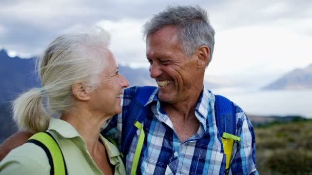 Loving Caucasian male and female seniors enjoying leisure trekking The Remarkables Lake Wakatipu New Zealand  - Footage, Video