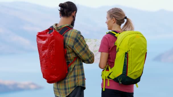 Active Caucasian adventure couple reading map on the hike of Mt Aspiring Lake Wakatipu New Zealand  - Footage, Video
