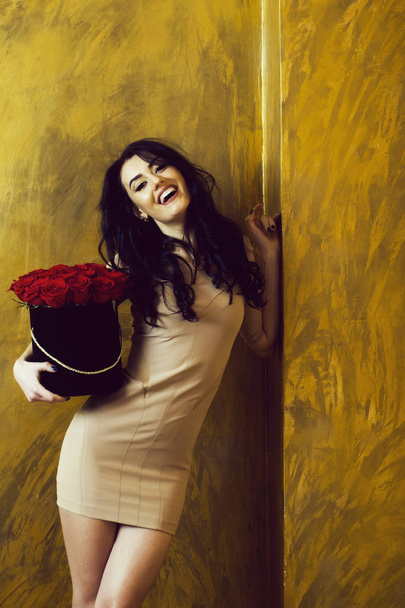 Pretty happy girl smiling with red roses in box - Foto, Imagen
