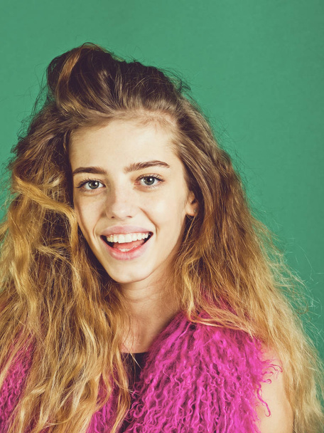 girl, happy model with natural, long hair in pink boa - Fotó, kép