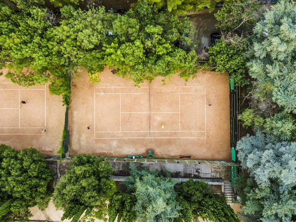 aerial sunny summer tennis courts top view from above near the sea in the city park - Photo, Image