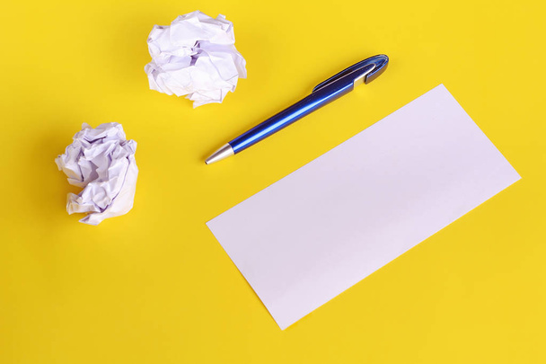 Empty paper with crumpled paper balls on yellow background. Copy space. Brainstorming concept - Foto, immagini