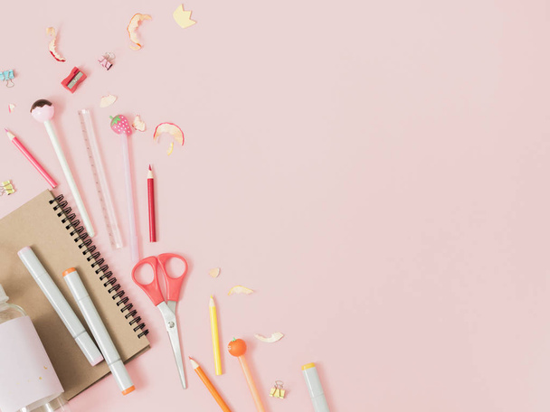 Colorful stationery and candies on pastel pink background, school concept - Foto, afbeelding