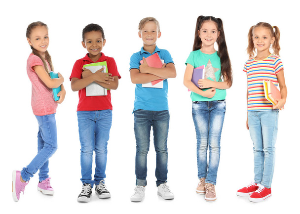 Cute school children with stationery on white background - Zdjęcie, obraz