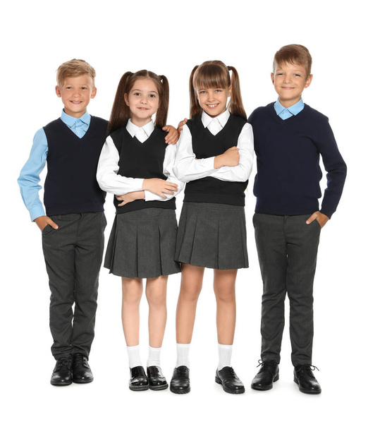 Little children in stylish school uniform on white background - Фото, изображение