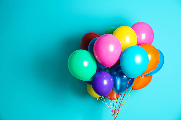 Bunch of bright balloons on color background with space for design - Photo, image